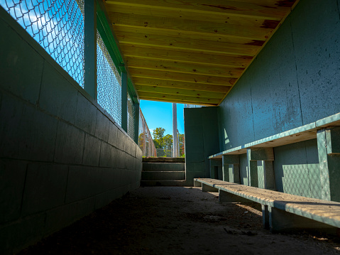 Small baseball dugout low angle inside view on a sunny day