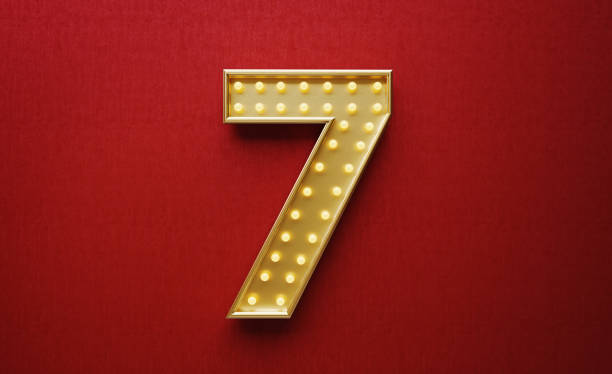 istock Light Bulbs Forming Number Seven on Red Background 1188531998