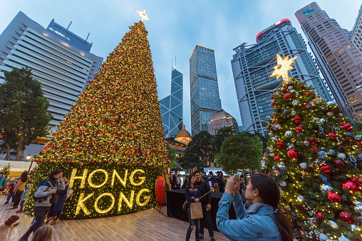 Hong Kong, China - December 24, 2015 : people taking photo in front of Christmas tree in Central district of Hong Kong, China.