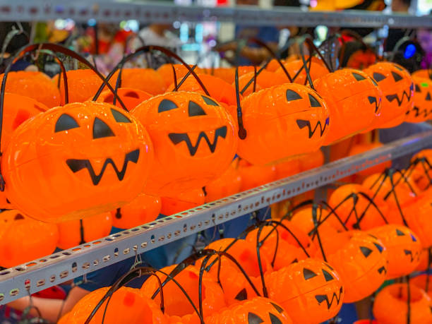Orange jack o lanterns for sale in Halloween season stock photo