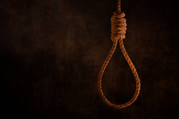 istock Rusty steel ropes noose for hanging with grunge rust wall background dark black and dim light 1188538135