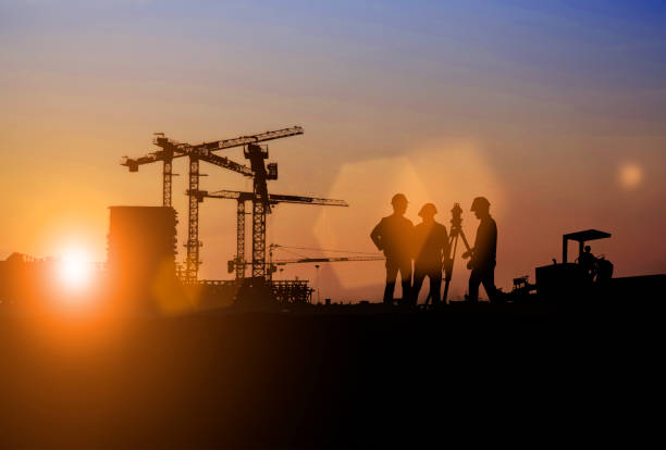 istock Silhouette of Survey Engineer and construction team working at site over blurred  industry background with Light fair Film Grain effect.Create from multiple reference images together 1188545096