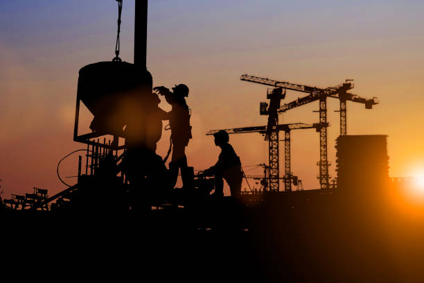istock Silhouette of Survey Engineer and construction team working at site over blurred  industry background with Light fair Film Grain effect.Create from multiple reference images together 1188545100