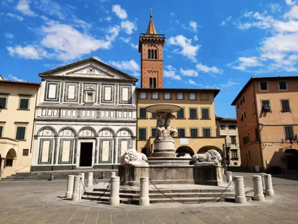 The ancient lion fountain and the Collegiata di Sant' Andrea church in Farinata degli Uberti square, Empoli, Florence province, the most important place of worship in the town. Tuscany