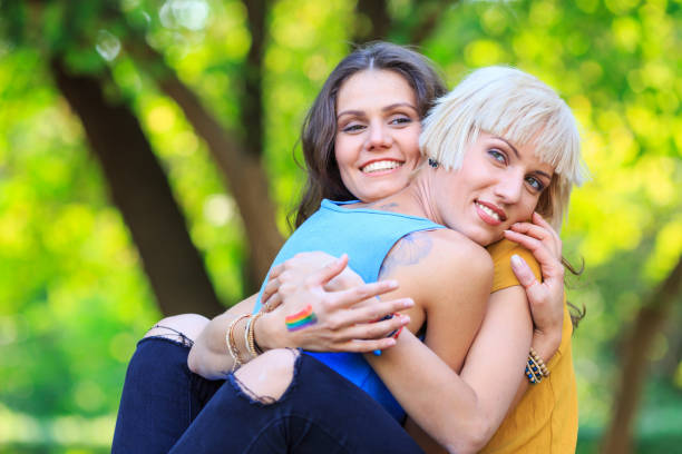 istock Two young women sitting in park and resting 1188550219