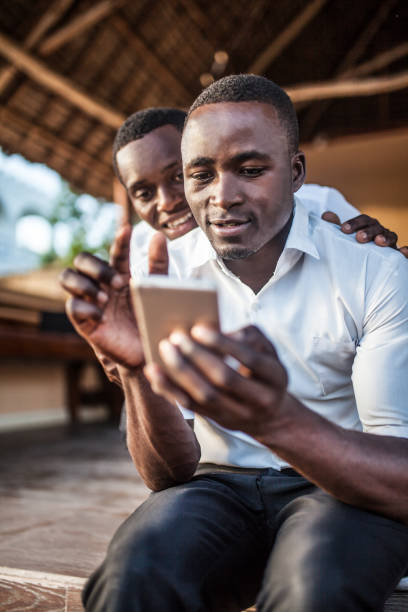 istock African teenager with mobile 1188553097
