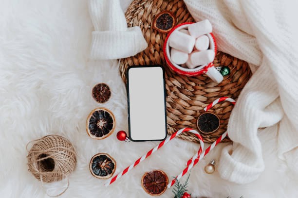istock Christmas background with mobile phone with blank white screen,  Flat lay, top view. Christmas application mock up template 1188561688