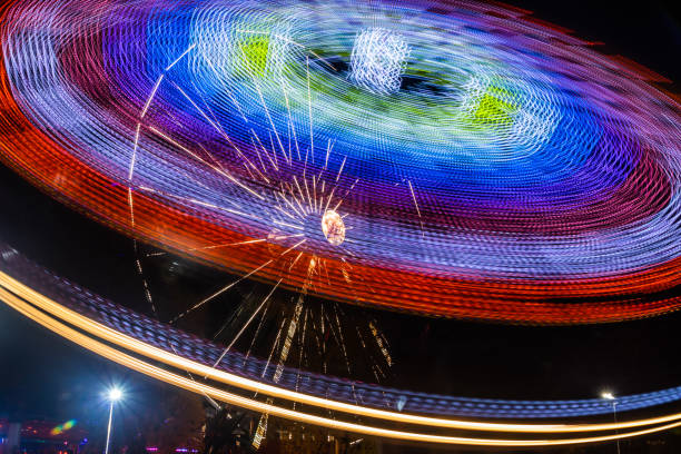 istock Two rides in motion in amusement park, night illumination. Long exposure. 1188562146