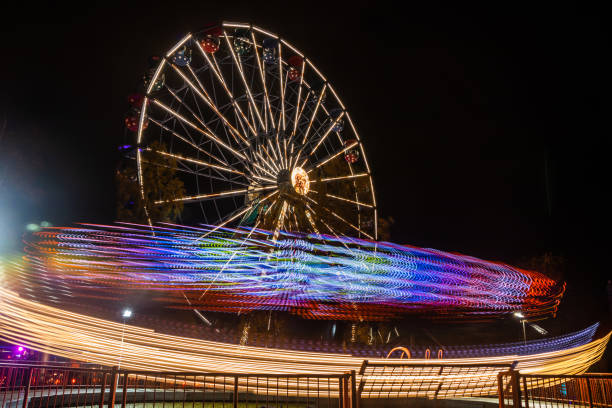 istock Two rides in motion in amusement park, night illumination. Long exposure. 1188562178