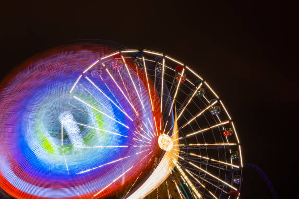 istock Two rides in motion in amusement park, night illumination. Long exposure. 1188562199