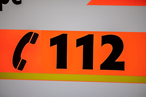 emergency number 112 on a German ambulance car with the unicode sign for telephone