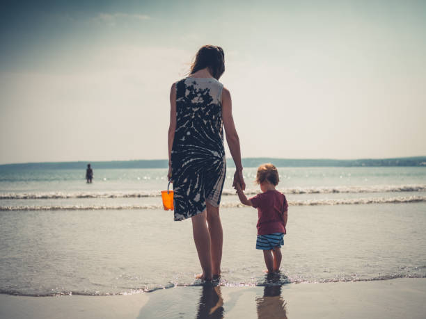 istock Young mother with little boy at the beach 1188564207