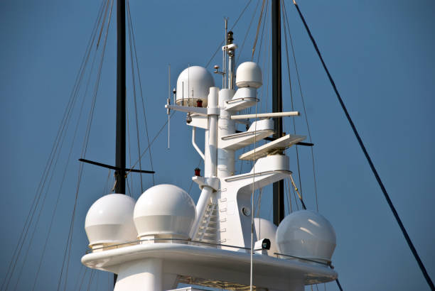 the upper part is the roof of a luxurious white yacht against sky - sea safety antenna radar imagens e fotografias de stock