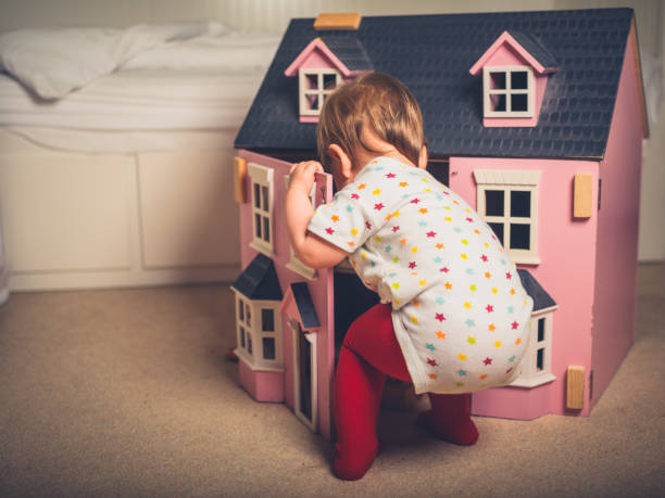 istock Toddler playing with doll house 1188564825