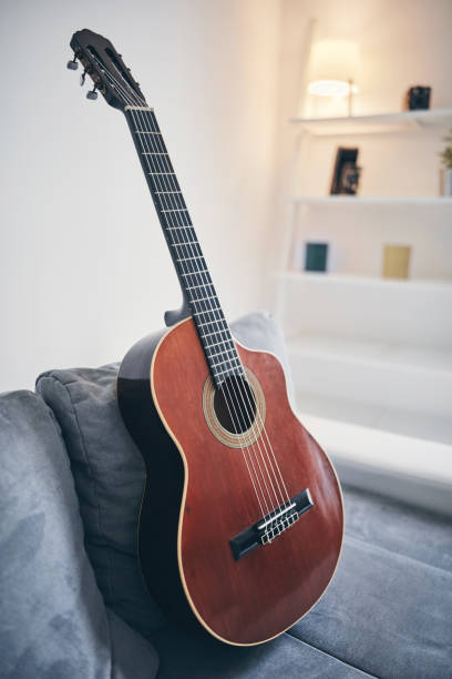 istock Acoustic guitar on a living room couch / sofa. 1188568213