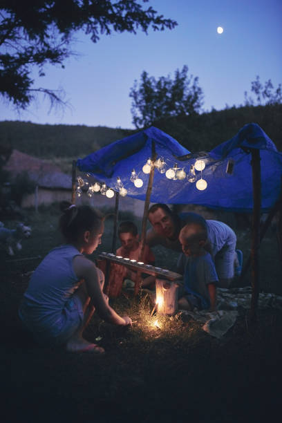 istock Father with children playing under their backyard tent. 1188568466