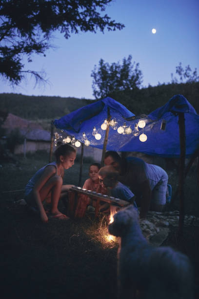 istock Father with children playing under their backyard tent. 1188568815