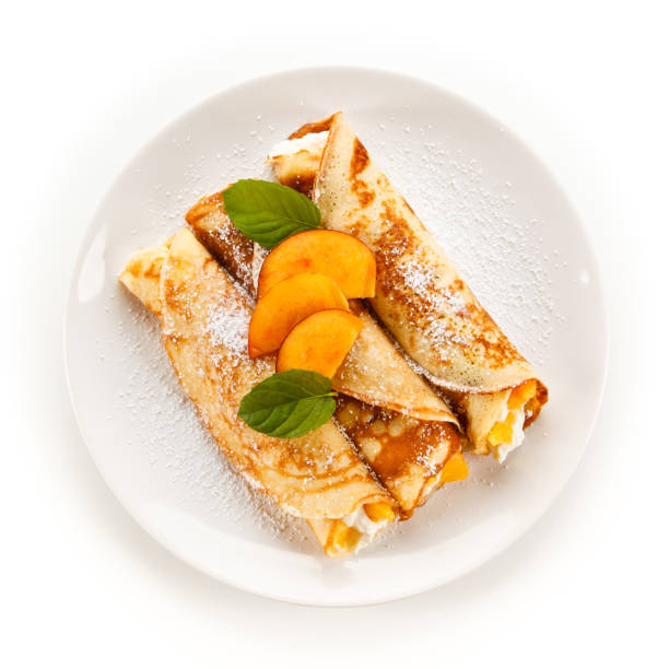 istock Crepes with cream and apricot on white background 1188570676
