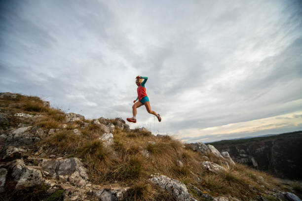 istock Young woman running on mountain 1188572106