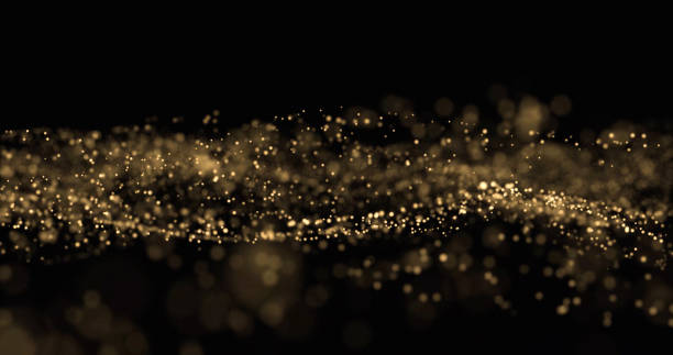 istock Gold glitter, light particles wave splash on black background. Shining gold sparks, shimmering sparkles glow, magic bright glitter with bokeh effect 1188573571