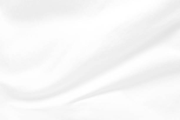 istock White cloth background abstract. Fabric is wrinkled and sofe wave. Material are used in textile assembly. 1188574392