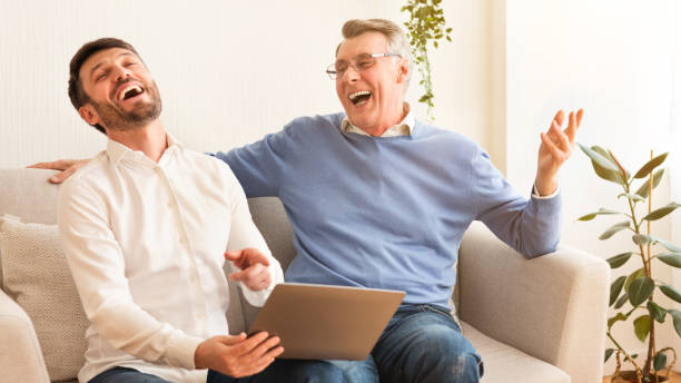 istock Middle-Aged Man And Elderly Father Using Laptop Sitting Indoor, Panorama 1188574520