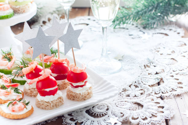 istock Assorted appetizers canapes with shrimps - with fresh cucumbers, cherry tomatoes, bread, crackers on the festive table, horizontal, copy space 1188575187