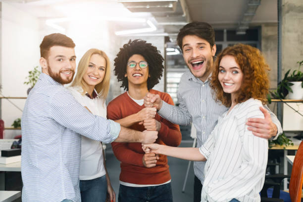 istock Business colleagues building tower from fists at office 1188577868