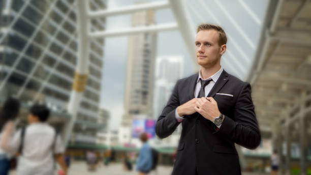 istock Businessman Looking Away While Standing Against Buildings 1188579816