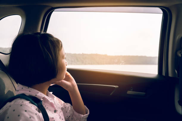 istock Girl Looking Through Window While Sitting In Car 1188579967
