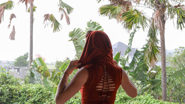 istock Young woman relaxes in tropical rainforest 1188580661