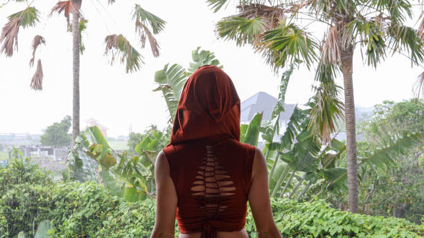 istock Young woman relaxes in tropical rainforest 1188580774