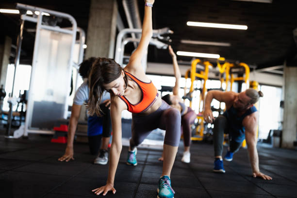 istock Healthy young people doing exercises at fitness studio. 1188581327