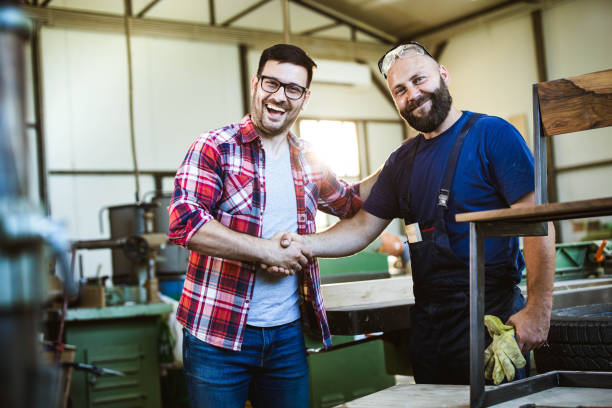 istock Happy customer and manual worker shaking hands in a workshop. 1188581651