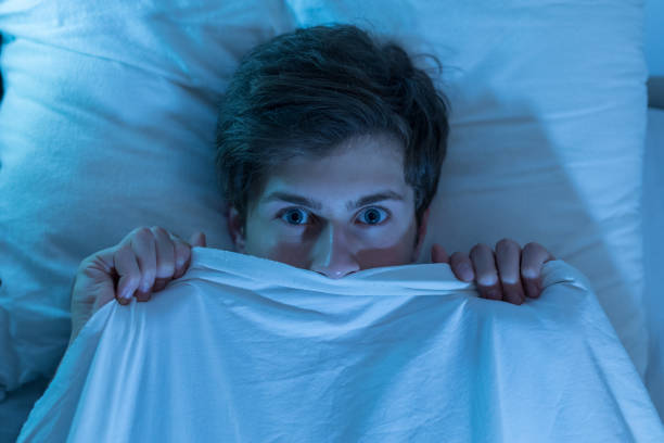 istock Young man hiding in bed under the blanket 1188581721