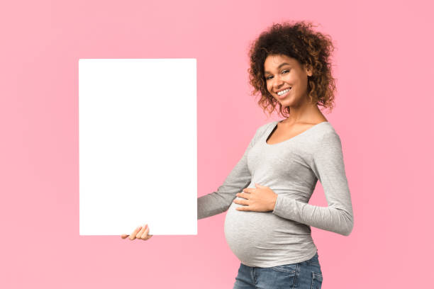 Smiling expectant woman with blank white paper