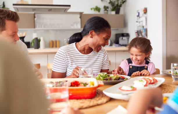istock Multi-Generation Mixed Race Family Eating Meal Around Table At Home Together 1188582629