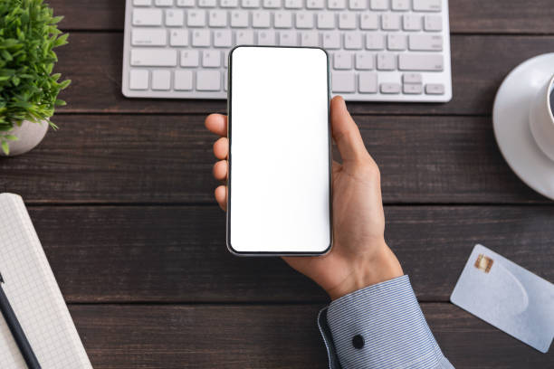 istock Unrecognizable office employee demonstrating smartphone with blank screen at workplace 1188583284