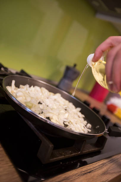 istock Chef Adding Oil in Cooking Pan - Stock Photo 1188584367
