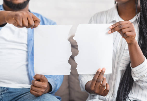 African american couple holding torn piece of paper Unrecognizable african american couple holding torn blank piece of paper, closeup pictures of divorce papers stock pictures, royalty-free photos & images