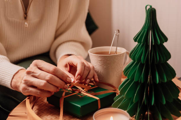 istock Woman wrapping gift and having tea 1188585798