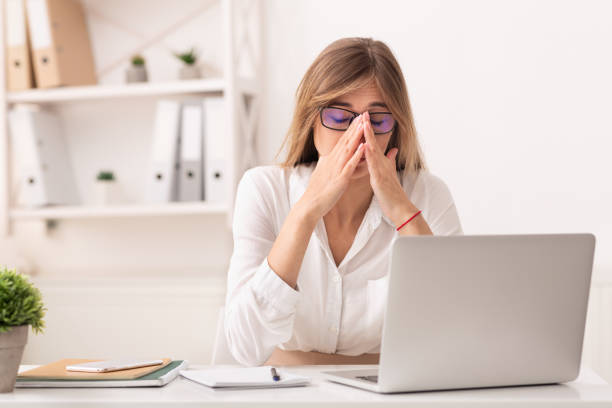 istock Lady Touching Nosebridge Having Sinusitis Sitting At Laptop At Workplace 1188587787