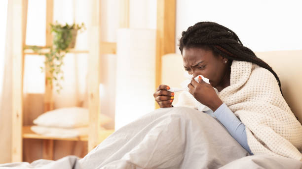 istock Sick Afro Woman Blowing Runny Nose Sitting In Bed, Panorama 1188587877