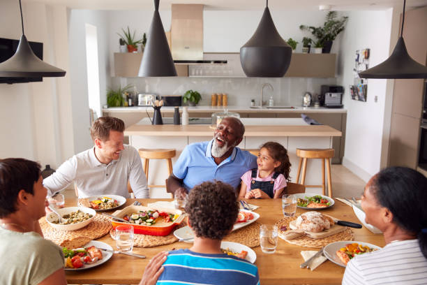 istock Multi-Generation Mixed Race Family Eating Meal Around Table At Home Together 1188588300