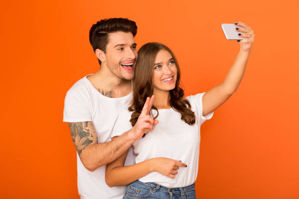 istock Married couple taking selfie, man showing peace gesture 1188588727