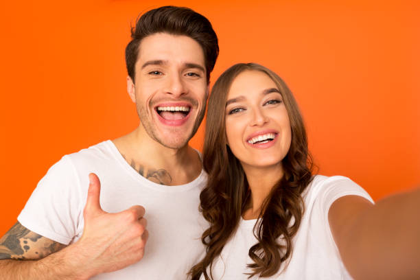 istock Excited couple making selfie together, guy showing thumb up 1188588741