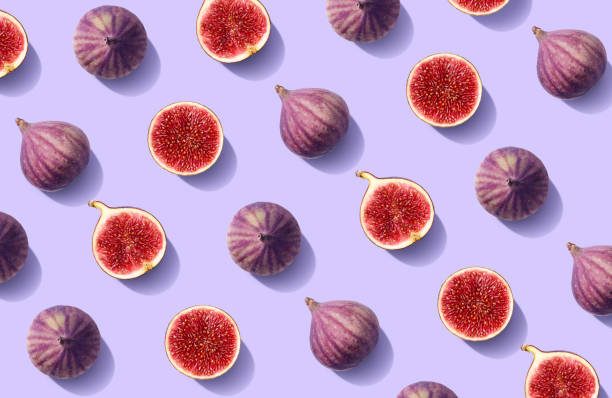 Colorful fruit pattern of fresh figs Colorful fruit pattern of fresh figs on purple pastel background, top view, flat lay fig photos stock pictures, royalty-free photos & images