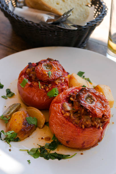 greek stuffed tomatoes, in greek gemista traditional dish filled with rice and basked of bread. taken in donoussa island, greece - greek islands greece day full frame imagens e fotografias de stock