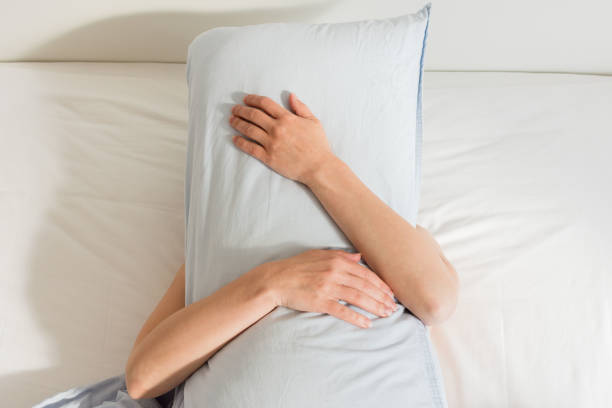 istock Woman sleeping on a white bed 1188593365