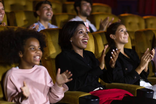 Diverse spectators applauding after show stock photo